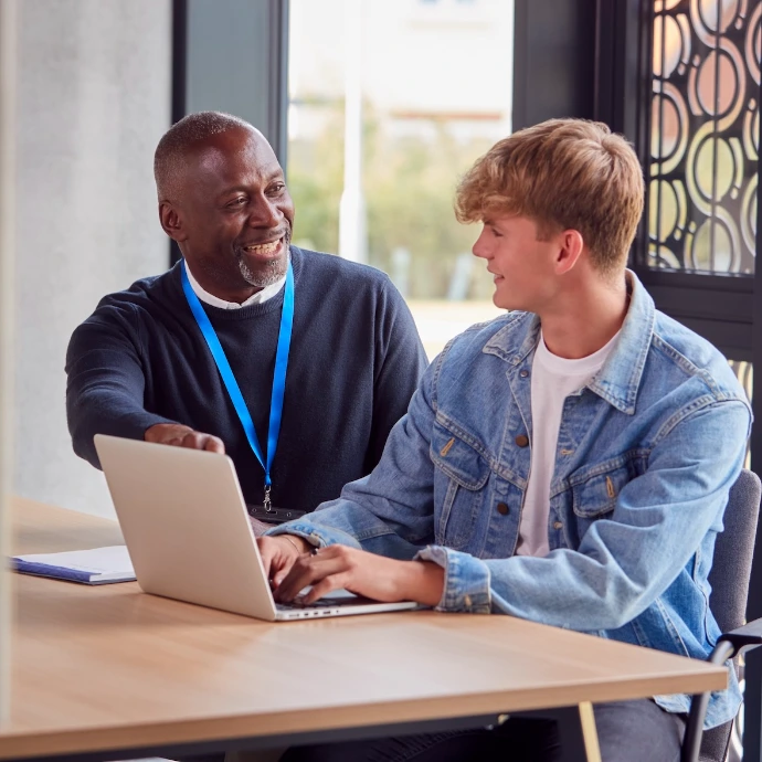 A professor sitting with his student